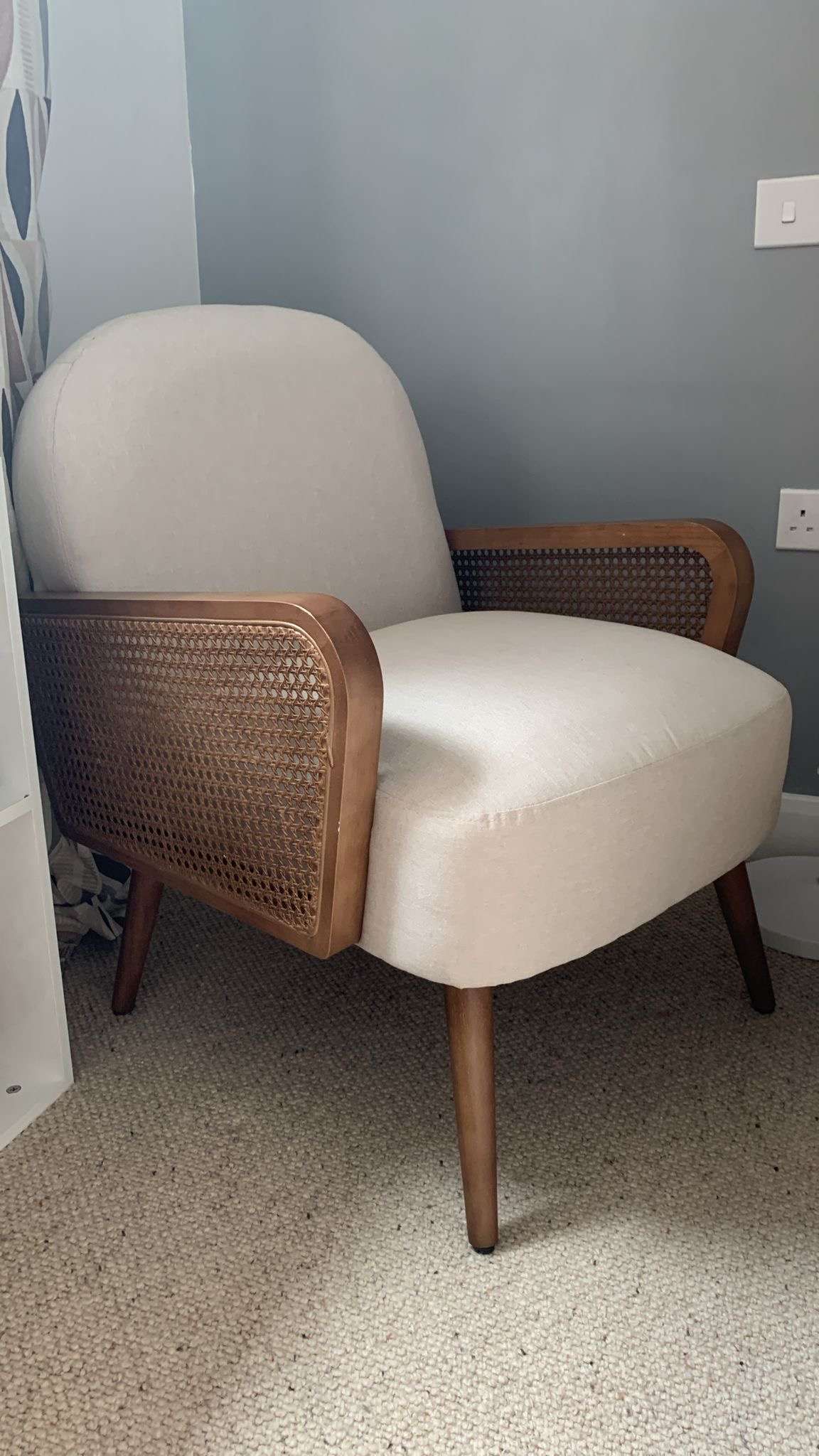 Armchair with rattan armrests