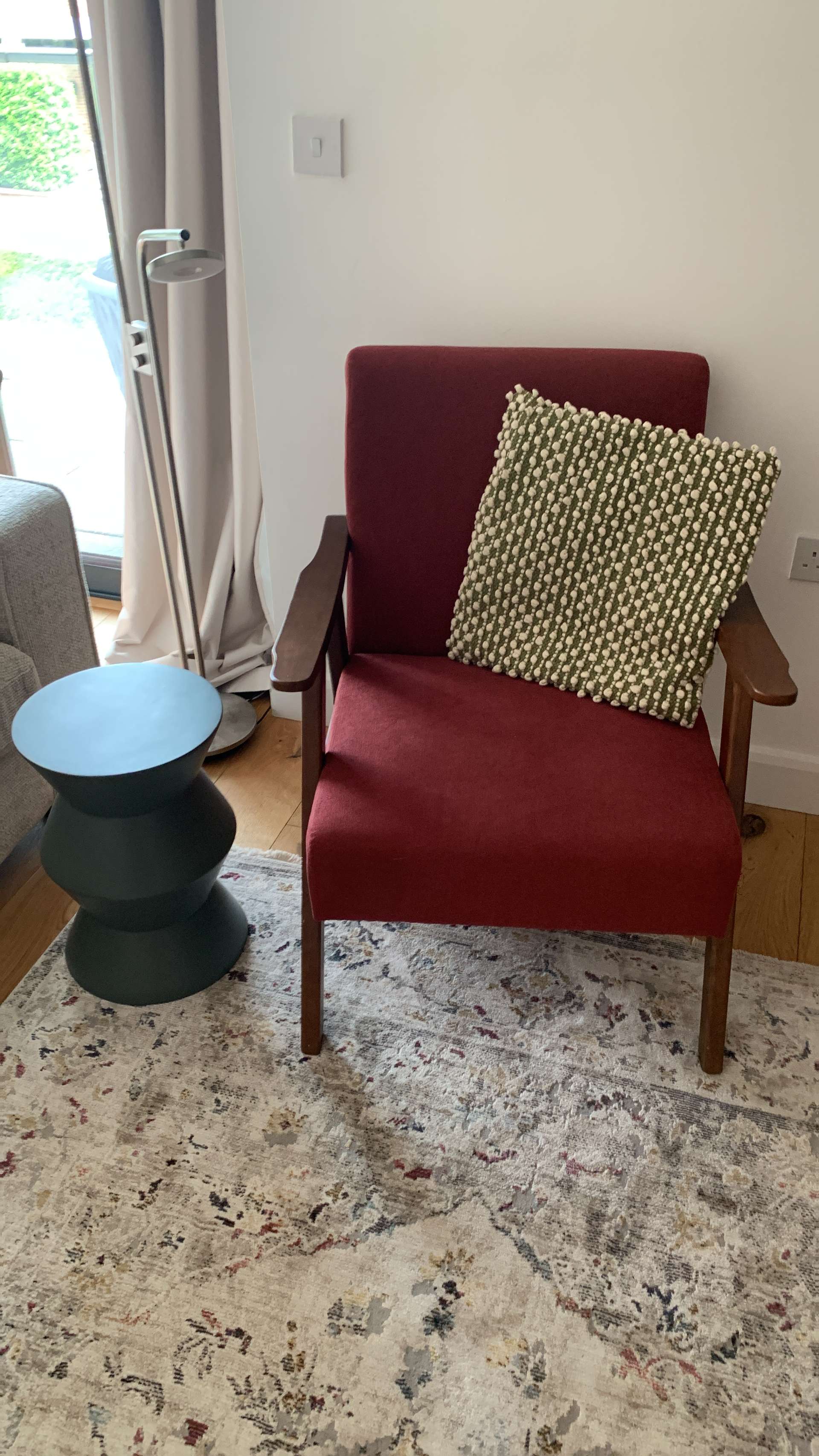 Red armchair and green cushions combination. Third slide